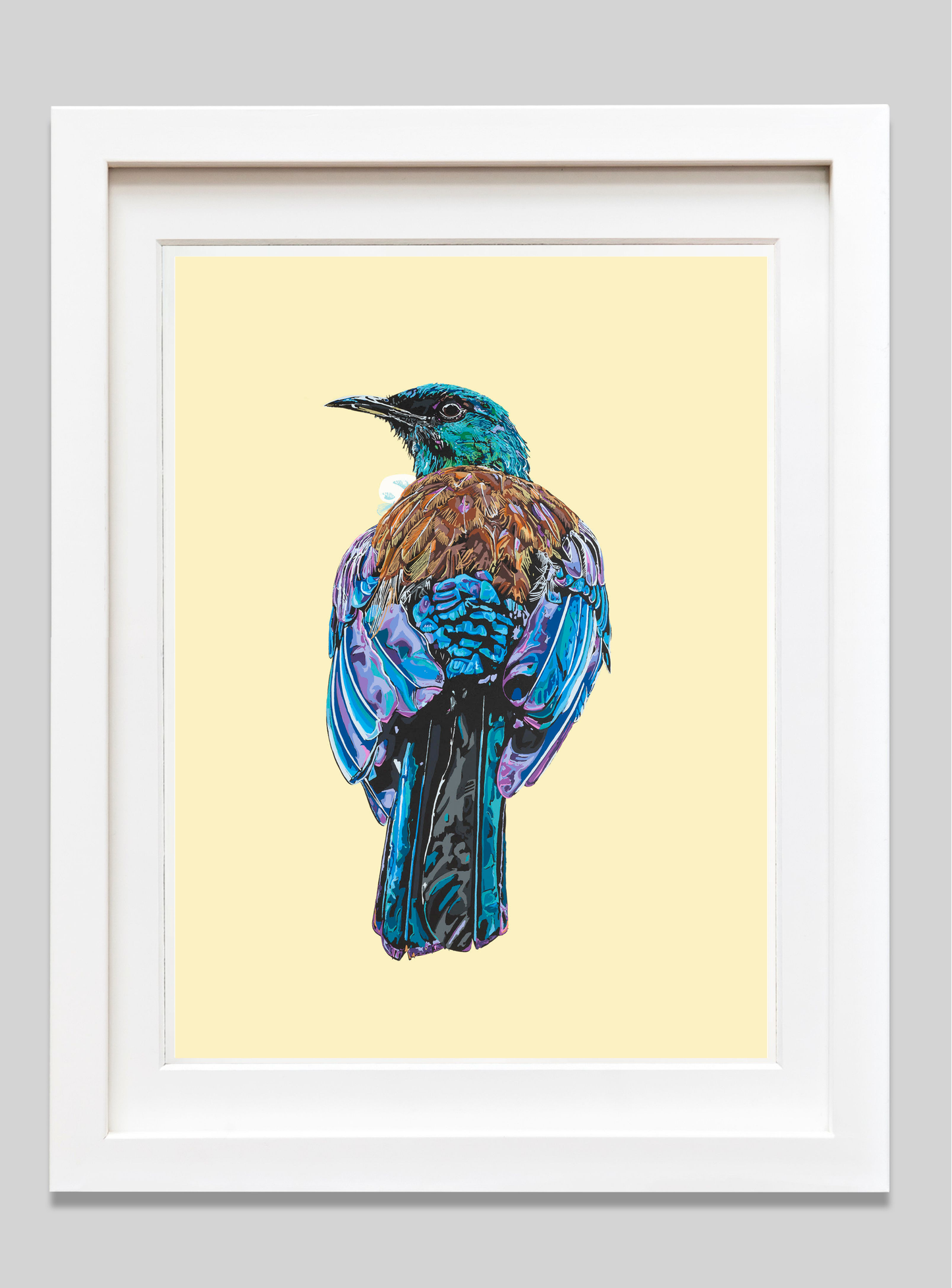 Framed artwork of a colorful bird on a light yellow background