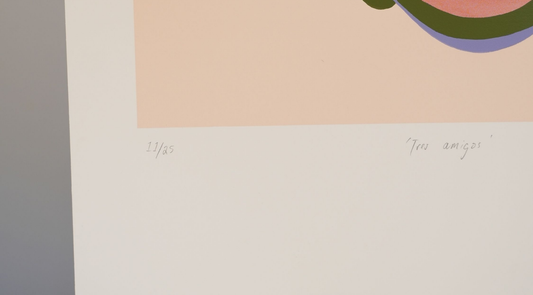 Close-up of a limited edition art print showing the edition number "11/25" and the handwritten title "Tres amigos" in the bottom margin.