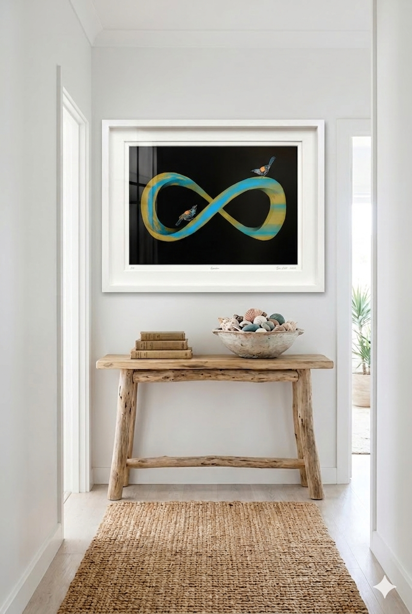 Framed abstract art on a wall above a wooden console table with decorative items.