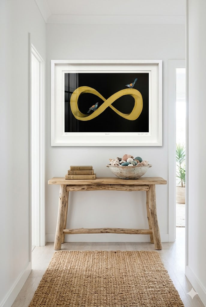 Framed artwork of a yellow infinity symbol on a wall above a wooden console table.