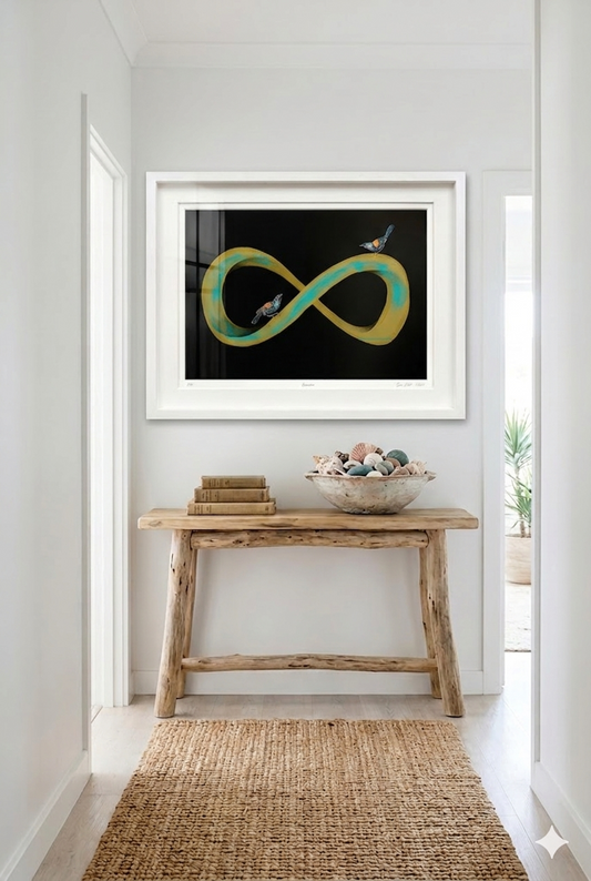 Gold and green infinity symbol artwork in a a white frame. Situated in a home setting above a table
