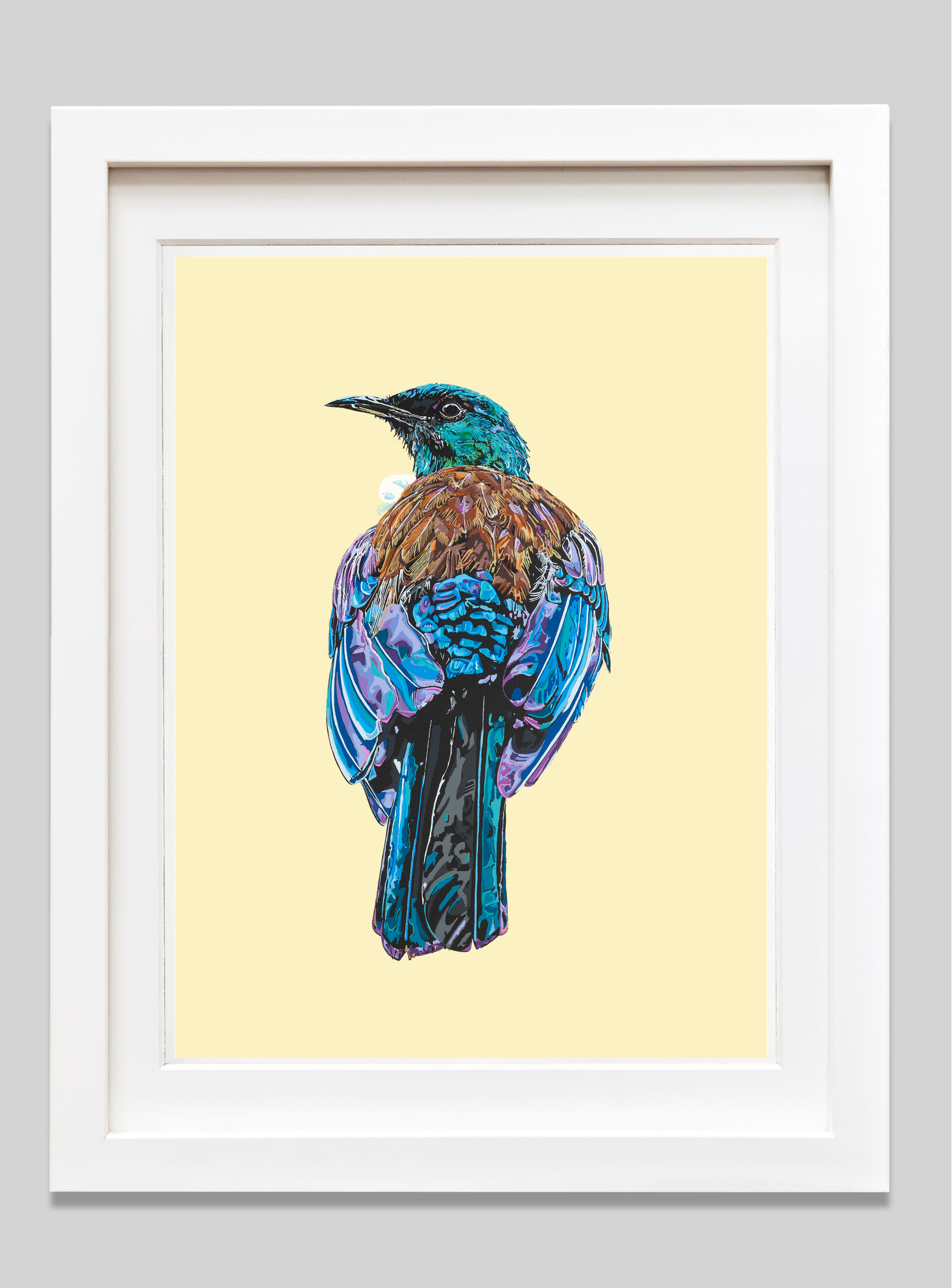 Framed artwork of a colorful bird on a light yellow background
