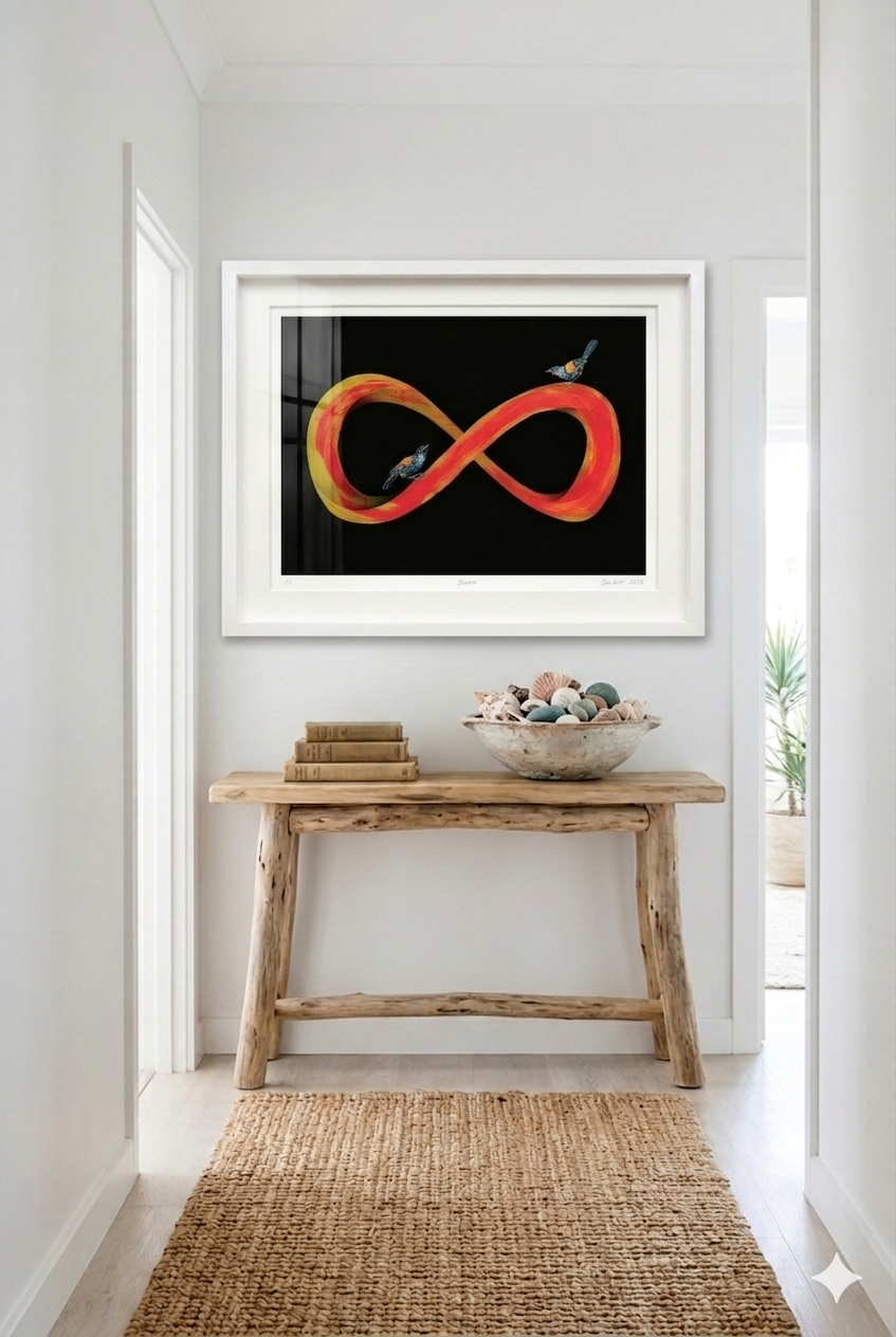 Framed abstract artwork on a wall above a wooden console table with decorative items.