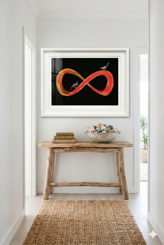 Framed abstract artwork on a wall above a wooden console table with decorative items.